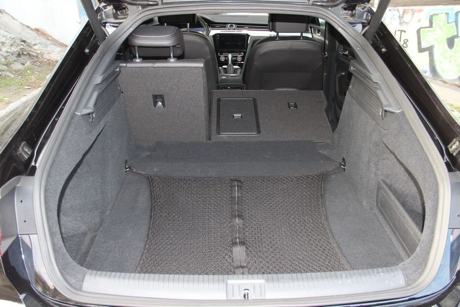 На фото вид сзади на открытый багажник автомобиля Volkswagen Arteon, который можно защитить резиновым ковриком