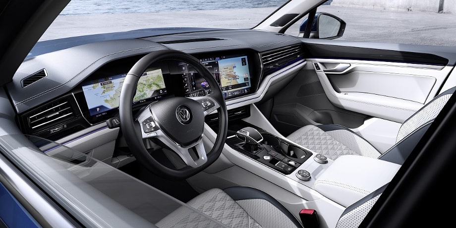 На фото светлый салон Volkswagen Touareg III поколения с виртуальной панелью приборов и большим сенсорным экраном
